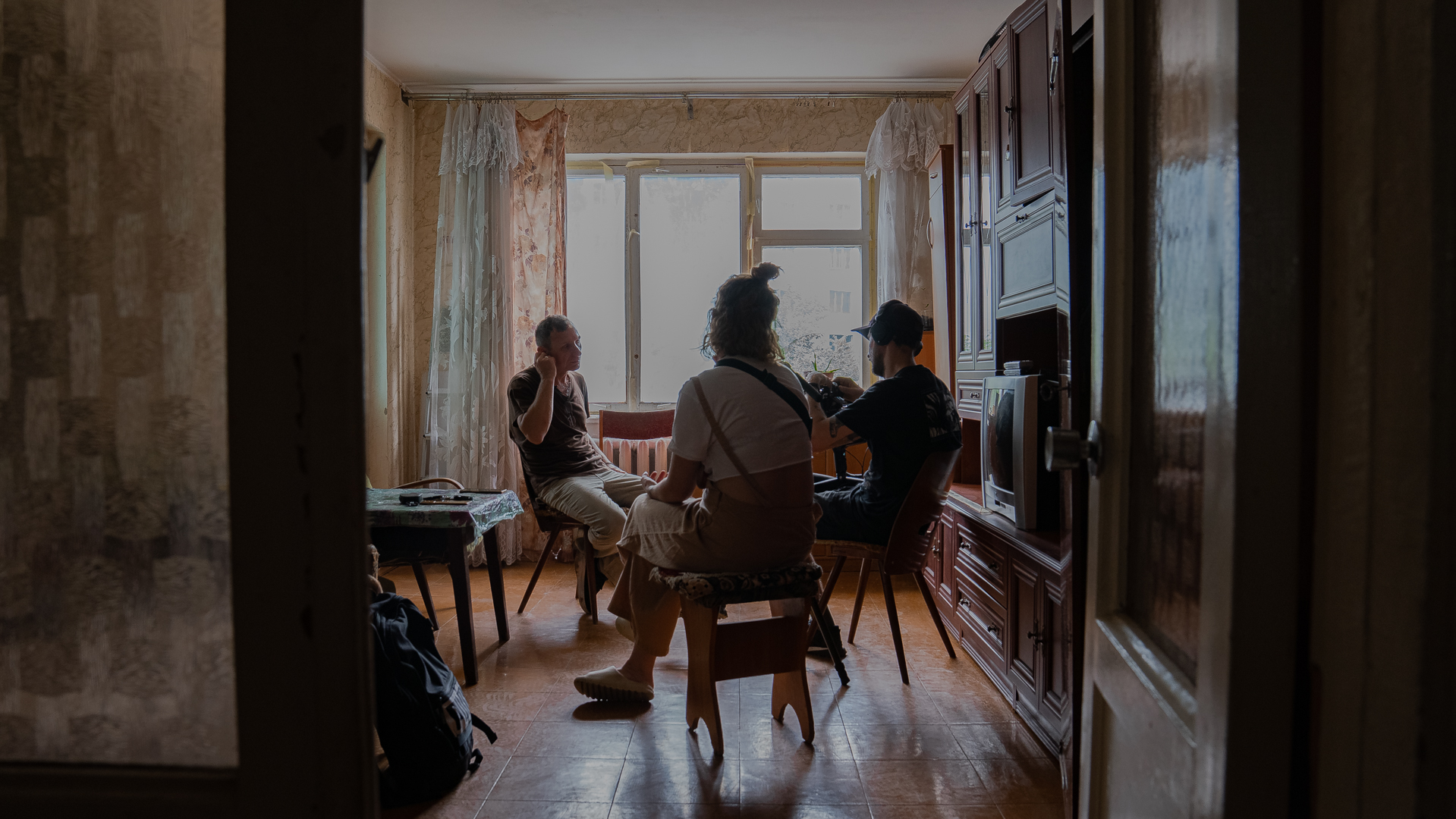 group of people sitting in an apartment