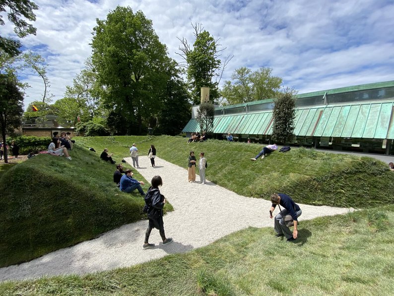 People relaxing outside next to a building