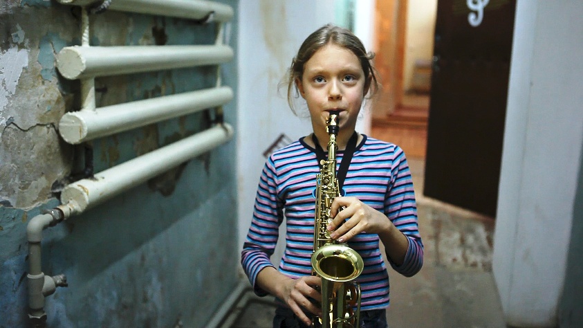 girl playing saxophone