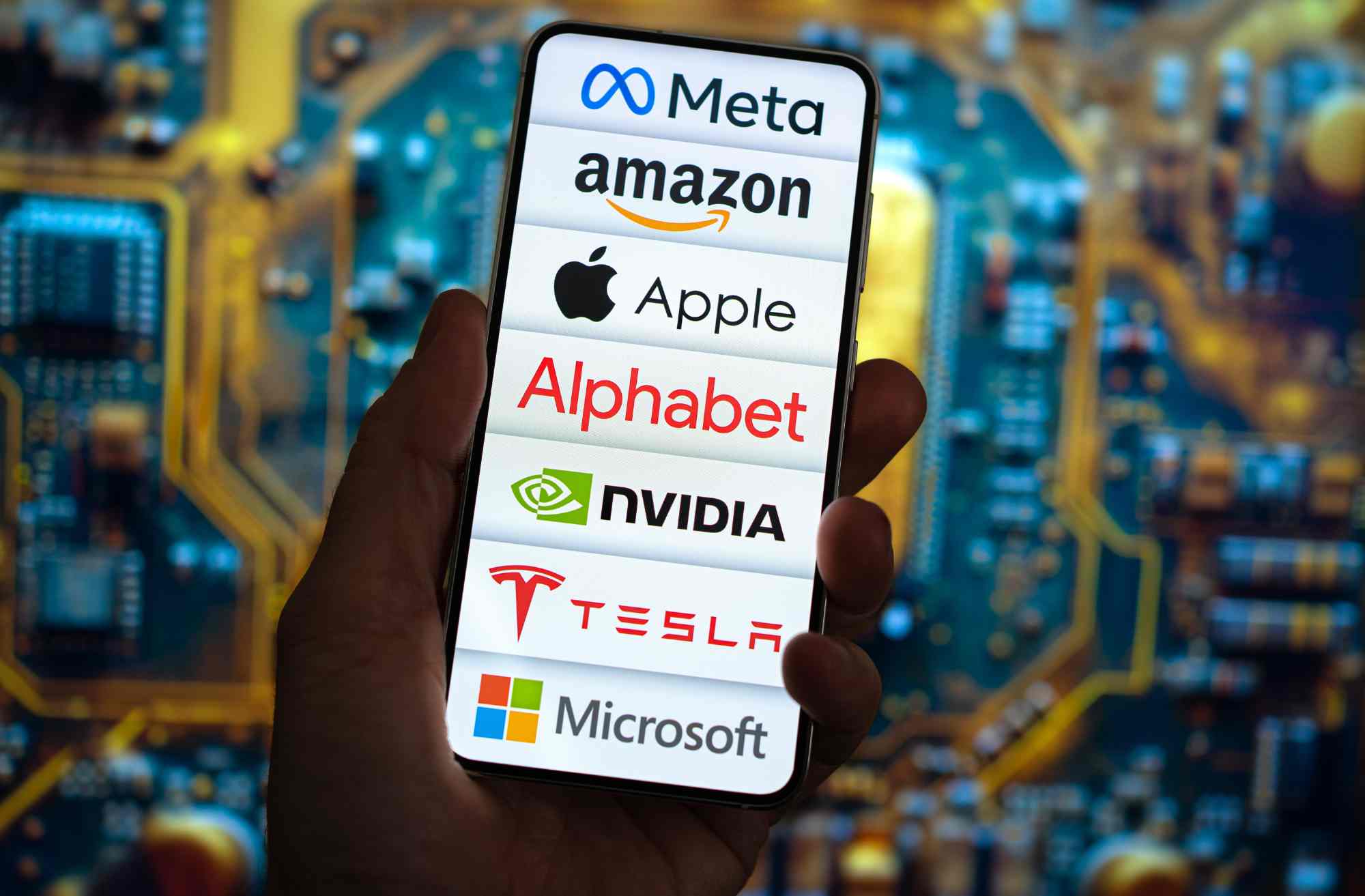 Someone holding a smartphone showing a screen with different logos of well-known companies
