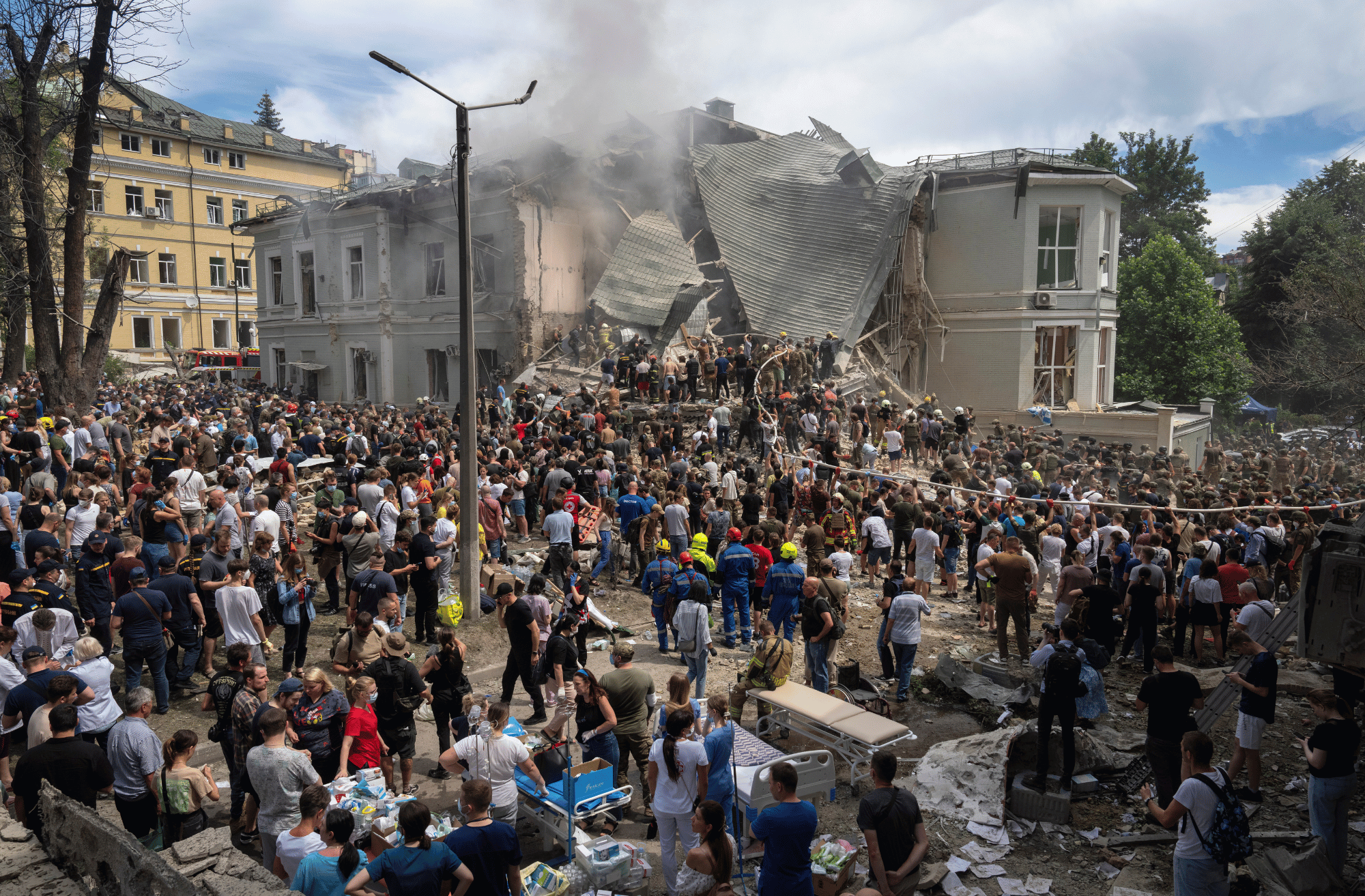 Rescuers and volunteers clean up the rubble and search victims after a Russian missile attack in Kyiv, July 8, 2024.