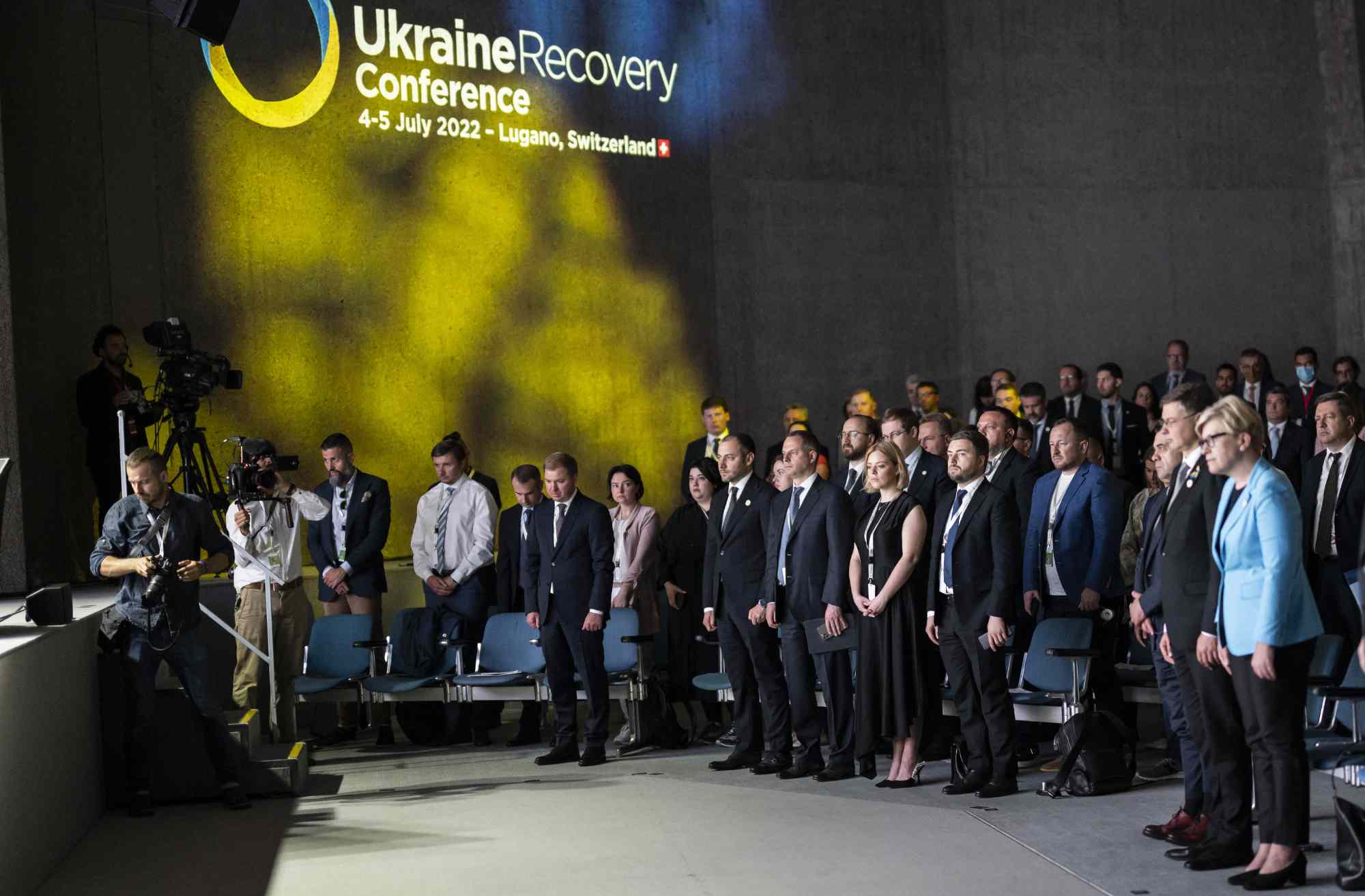 Participants observe a minute of silence during the closing plenary during the Ukraine Recovery Conference, July 5, 2022 in Lugano, Switzerland.