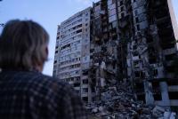 person looking at destroyed building