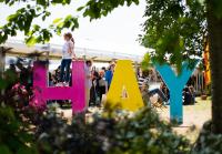 HAY Sign in different colors with people in the background 